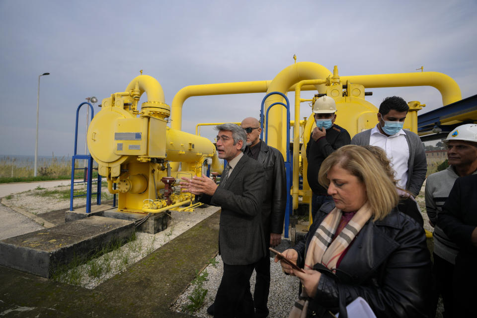 Lebanese Energy Minister Walid Fayad, left, tours the Biddawi oil facility in the northern city of Tripoli, Lebanon, Tuesday, Dec. 28, 2021. Fayad launched two projects in the country’s north on Tuesday to facilitate the flow of natural gas from Egypt. The move aims to improve electricity production and expand the country’s tanks to increase oil reserves. (AP Photo/Hassan Ammar)