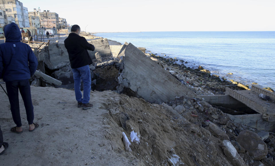 Residents inspect destroyed sewage pipes following overnight Israeli missile strikes, along the beach of Shati refugee camp, in Gaza City, Thursday, Feb. 6, 2020. Earlier on Wednesday, Israel struck Hamas militant targets in Gaza in response to rocket fire toward Israeli communities the previous night. (AP Photo/Adel Hana)