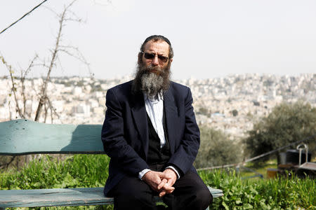 Baruch Marzel, from the Jewish Power political party, poses for a photograph during an interview with Reuters near his home in Hebron, in the Israeli-occupied West Bank February 24, 2019. REUTERS/Ronen Zvulun