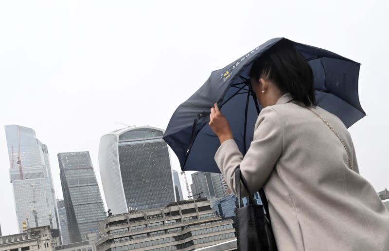 A woman crosses London Bridge in London