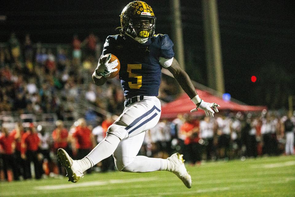 Shawn Simeon of the Naples High School football team runs for one of his seven touchdowns against Port Charlotte during the Region 3S-4 semifinal on Friday, Nov. 17, 2023. Naples won 63-33.