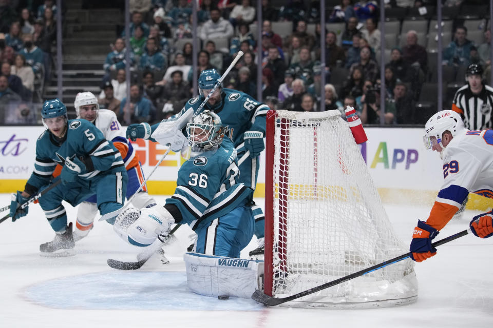 San Jose Sharks goaltender Kaapo Kahkonen (36) makes a save on a shot by New York Islanders center Brock Nelson, right, during the first period of an NHL hockey game in San Jose, Calif., Saturday, March 18, 2023. (AP Photo/Godofredo A. Vásquez)