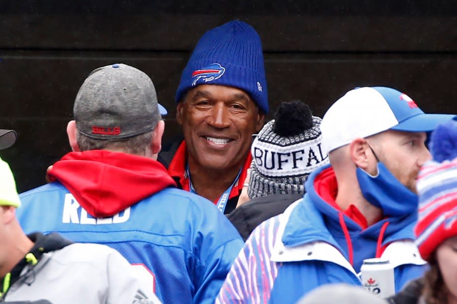 FILE – Buffalo Bills Hall of Fame running back O.J. Simpson with fans prior to an NFL football game against the Miami Dolphins, Sunday, Oct. 31, 2021, in Orchard Park, N.Y. O.J. Simpson, the decorated football superstar and Hollywood actor who was acquitted of charges he killed his former wife and her friend but later found liable in a separate civil trial, has died. He was 76. (AP Photo/Jeffrey T. Barnes, File)