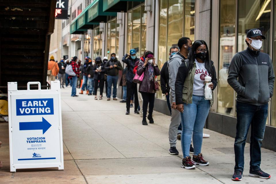 Hundreds of people wait in line to early vote in Chicago on  Oct. 1, 2020.