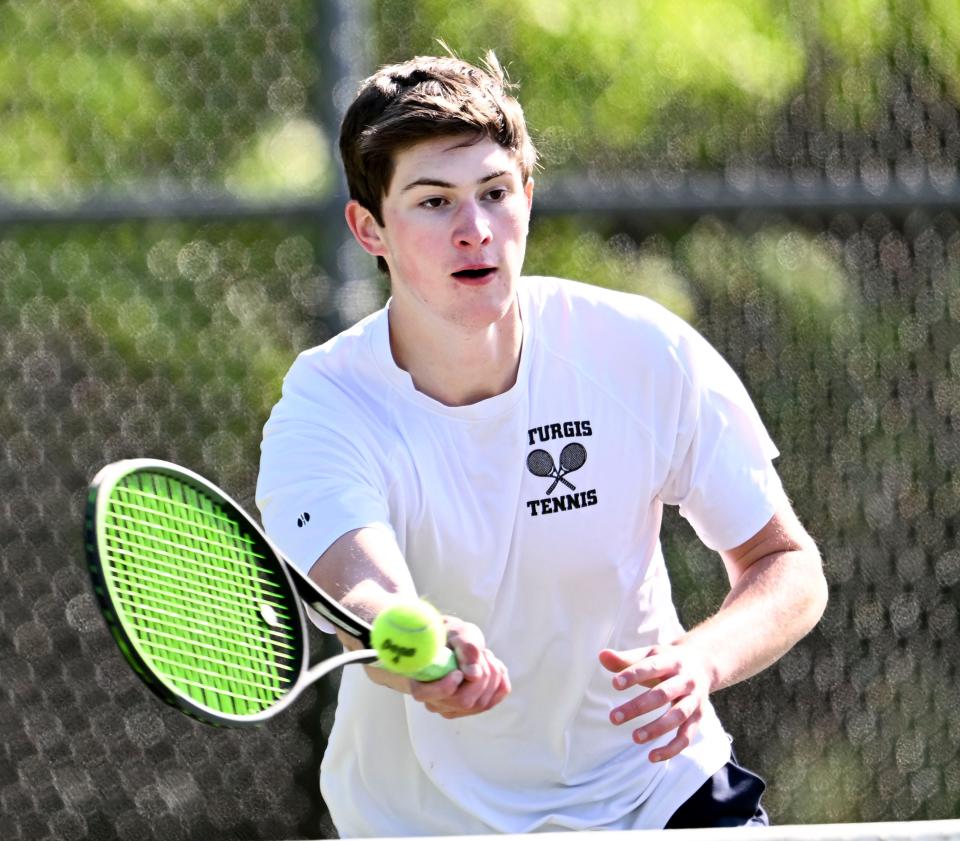 Sturgis number one doubles player Colby Hall goes to the net to return a Cape Cod Academy shot.