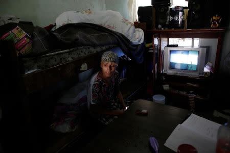 Daniel, who attends the meetings of Raza Nueva in Christ, a project of the archdiocese of Monterrey, sits on his bed in Escobedo, on the outskirts of Monterrey, Mexico, June 15, 2016. REUTERS/Daniel Becerril