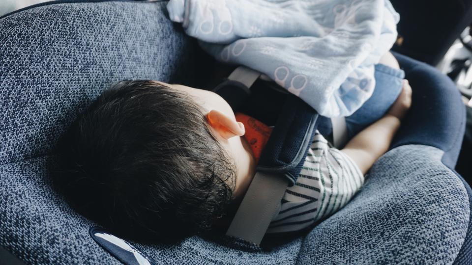  A boy sits in a car seat is pictured in a stock image.