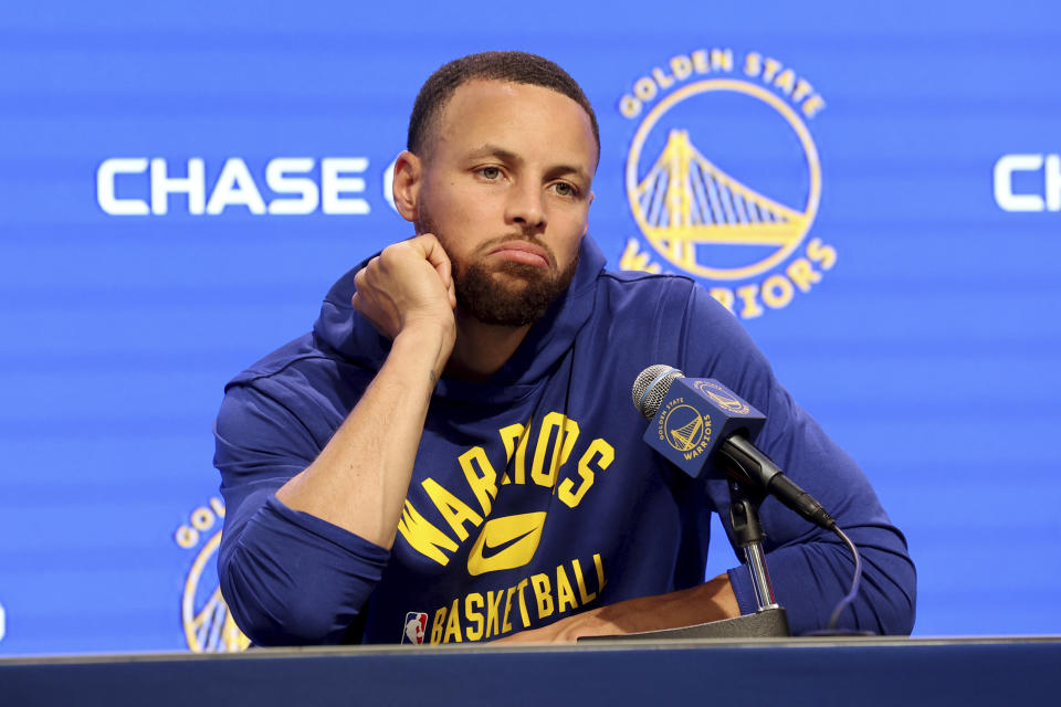 Golden State Warriors guard Stephen Curry talks to the media about his injury before an NBA basketball game against the San Antonio Spurs in San Francisco, Sunday, March 20, 2022. (AP Photo/Jed Jacobsohn, Pool)