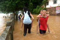 <p>People wade in a flooded street on July 2, 2017 in Yongfu, China. Heavy rainstorms hit south China since late June and caused severe floods in many parts of Hunan, Guangxi, Jiangxi and Sichuan. (Photo: VCG/VCG via Getty Images) </p>