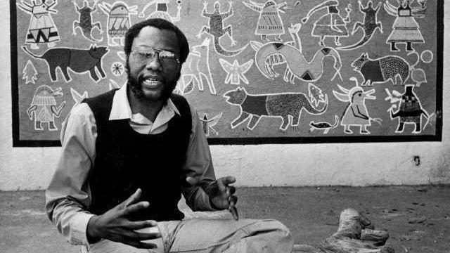 John Otterbridge sits with a creation at the African American Doll Exhibition