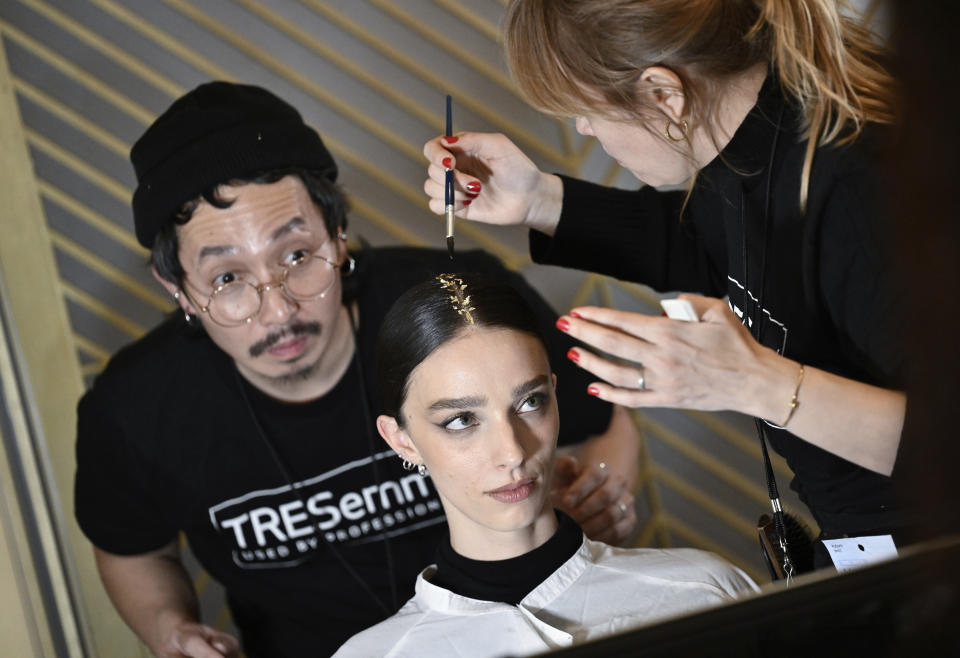 A model getting makeup applied backstage at the Christian Siriano Fall/Winter 2024 fashion show at The Plaza Hotel during New York Fashion Week on Thursday, Feb. 8, 2024, in New York. (Photo by Evan Agostini/Invision/AP)