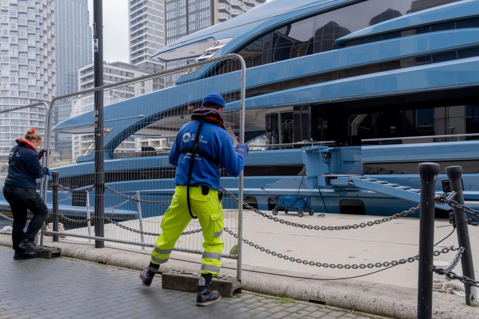 Security fencing is fitted to surround the super-yacht 'Phi' seized in London Docklands, impounded by the UK's National Crime Agency (NCA) because of sanctions against <span class="caas-xray-inline-tooltip"><span class="caas-xray-inline caas-xray-entity caas-xray-pill rapid-nonanchor-lt" data-entity-id="Vladimir_Putin" data-ylk="cid:Vladimir_Putin;pos:1;elmt:wiki;sec:pill-inline-entity;elm:pill-inline-text;itc:1;cat:OfficeHolder;" tabindex="0" aria-haspopup="dialog"><a href="https://search.yahoo.com/search?p=Vladimir%20Putin" data-i13n="cid:Vladimir_Putin;pos:1;elmt:wiki;sec:pill-inline-entity;elm:pill-inline-text;itc:1;cat:OfficeHolder;" tabindex="-1" data-ylk="slk:Putin;cid:Vladimir_Putin;pos:1;elmt:wiki;sec:pill-inline-entity;elm:pill-inline-text;itc:1;cat:OfficeHolder;" class="link ">Putin</a></span></span> associates. The boat's ownership is uncertain, but it is believed to be owned by a Russian businessman with links to Russian dictator Vladimir Putin. (Photo by Richard Baker / In Pictures via Getty Images)