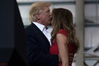 President Donald Trump revisited the style of the campaign trail at a Florida rally, while First Lady Melania Trump prayed before launching a strident defense of her husband