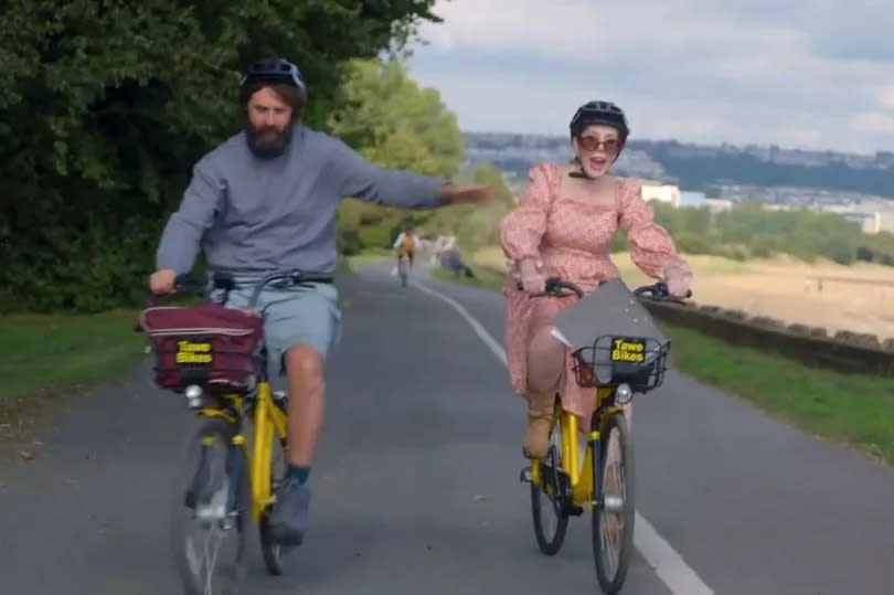 Two people cycling