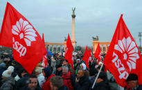 People holding the Hungarian Socialist Party (MSZP) flags gather during a protest against a proposed new labor law, billed as the "slave law", at the Heroes' square in Budapest, Hungary, December 16, 2018. REUTERS/Leonhard Foeger