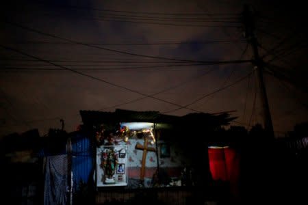 An altar is lit up at the camp known as No.3 in Mexico City, Mexico, October 16, 2017. The camp was founded in 1985 after an earthquake, which killed around 5,000 people. REUTERS/Carlos Jasso