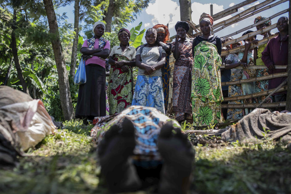 Relatives gather to identify victims in the village of Nyamukubi, South Kivu province, in Congo Saturday, May 6, 2023. The death toll from flash floods and landslides in eastern Congo has risen to 176, with some 100 people still missing, according to a provisional assessment given by the governor and authorities in the country's South Kivu province. (AP Photo/Moses Sawasawa)