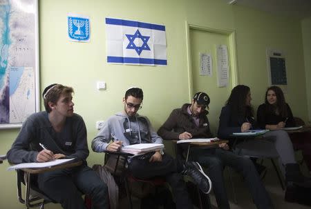 Newly arrived immigrants from France (from L to R) Jonathan Arbibe from Nice and Samuel Chemama, Alexandre Pequito, Myriam Bibas and Aurelie Serraf, all of whom are from Paris, study Hebrew at Ulpan Etzion, the original residential school and absorption centre, which has taught Hebrew to tens of thousands of immigrants since 1949, in Jerusalem, January 20, 2015. REUTERS/Ronen Zvulun