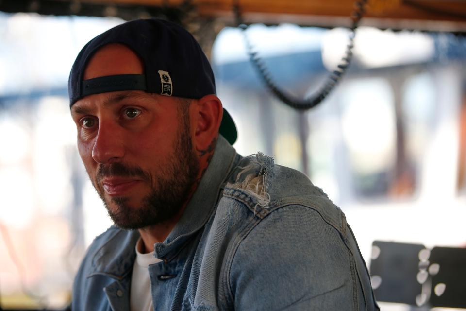 Tyler Miranda, captain of the F/V Mirage, sits in the wheelhouse of the New Bedford scalloper.