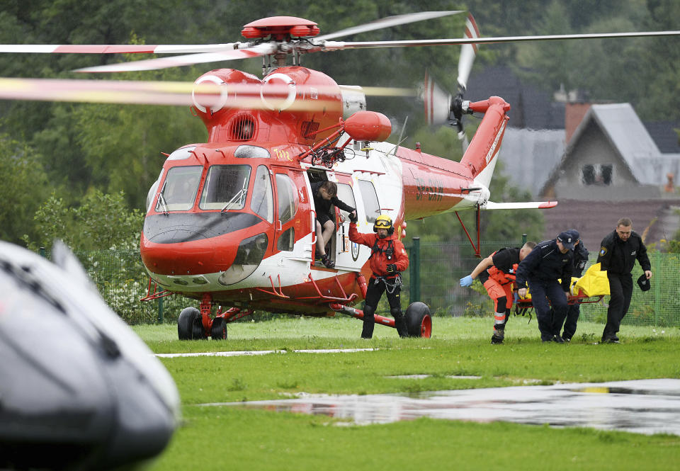 Rescue helicopter have brought to hospital the first people injured by a lighting that struck in Poland's southern Tatra Mountains during a sudden thunderstorm, in Zakopane, Poland, on Thursday, Aug. 22, 2019. (AP Photo/Bartlomiej Jurecki)