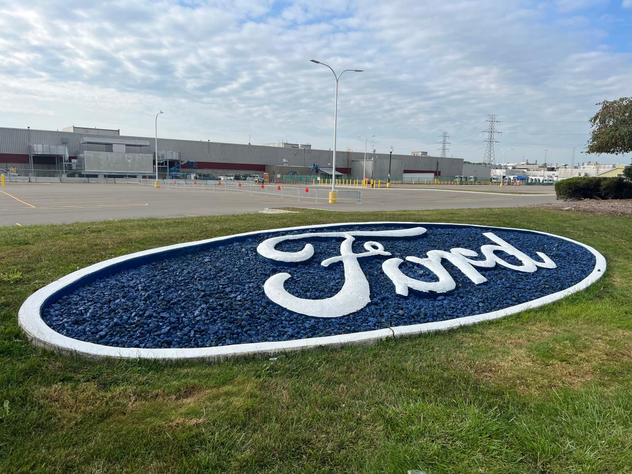 A Ford logo decorates the grass outside the Michigan Assembly Plant in Wayne on Sunday, Sept. 17, 2023.
