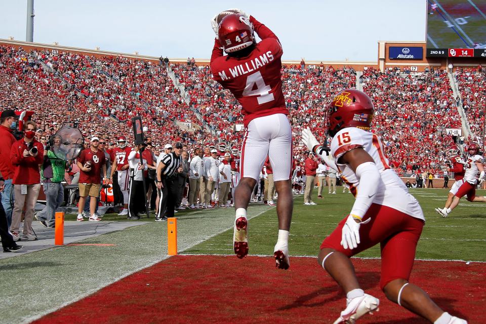 OU's Mario Williams (4) catches a touchdown pass beside Iowa State's Myles Purchase (15) during a 28-21 win Saturday in Norman.