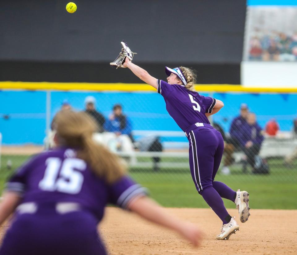 Northwestern's Bridget Donahey (5) reaches up for a fly ball that tips off her glove and drops in the outfield during their game at the Mary Nutter Collegiate Classic softball tournament in Cathedral City, Calif., Friday, Feb. 24, 2023.