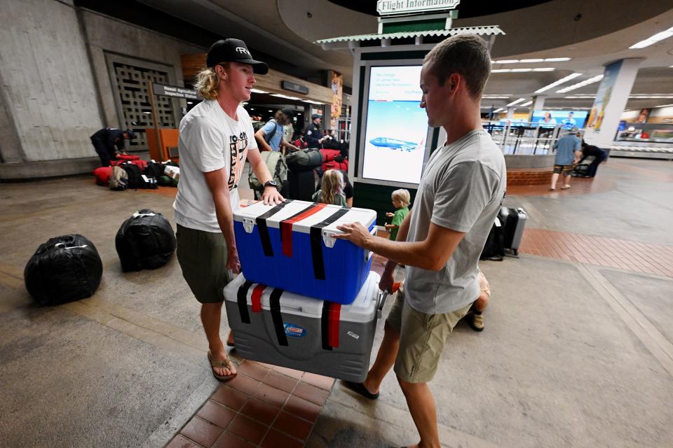 Friends of T and Lindsay Hughes help to carry supplies brought from the mainland out of the Kahului Airport as response to the Maui fire, which destroyed a large portion of the town of Lahaina, Hawaii, continues to come in from neighboring islands and the mainland on Wednesday, Aug. 16, 2023. | Scott G Winterton, Deseret News