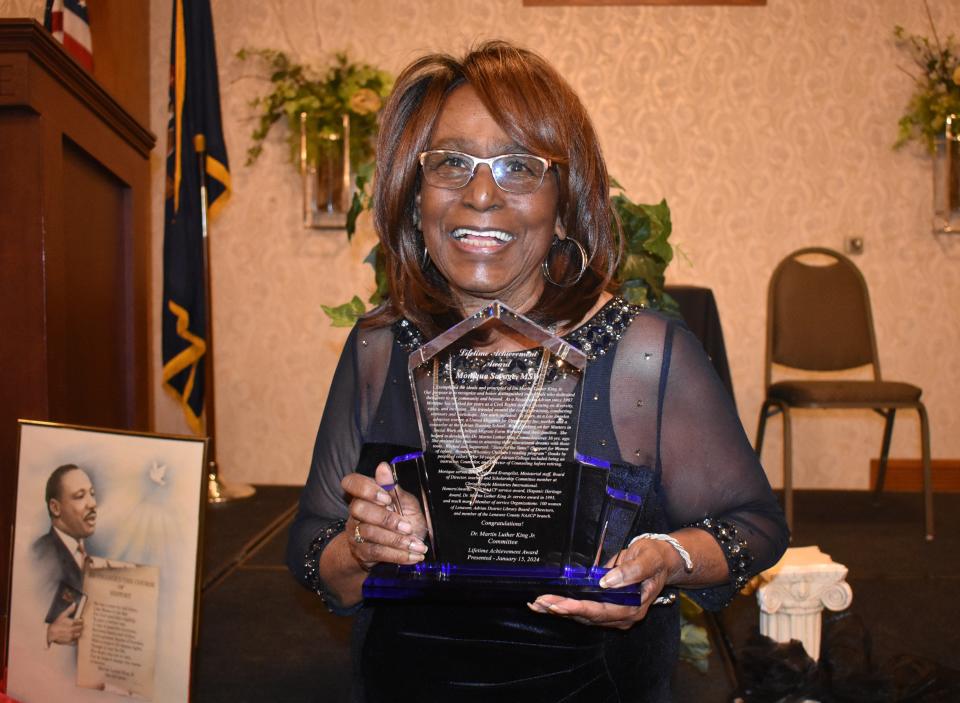 Monique Savage poses with the Lifetime Achievement Award she received Monday, Jan. 15, 2024, during Adrian's annual Martin Luther King Jr. Day Celebration and Dinner held on the campus of Adrian College. Savage is the sixth all-time recipient of the award, dating back to 2019 when it was awarded to Larry Richardson.