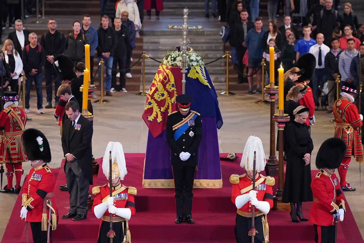 Queen Elizabeth II’s grandchildren hold a vigil beside her coffin as it lies in state on the catafalque in Westminster Hall (Yui Mok/PA) (PA Wire)