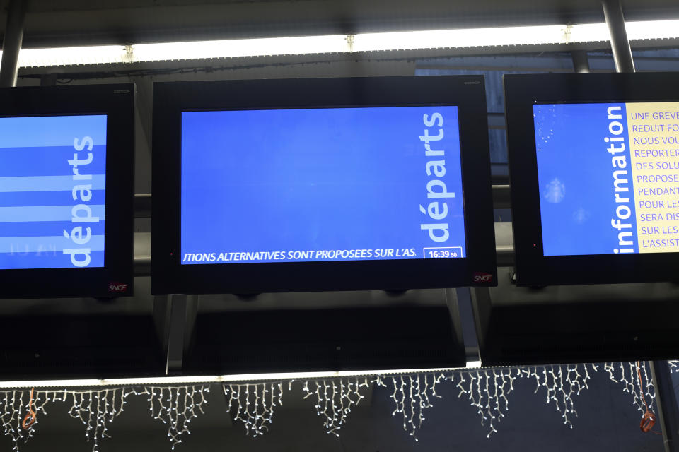 Information screens for departures remain empty at the Gare Montparnasse train station, Friday, Dec. 6, 2019 in Paris. Frustrated travelers are meeting transportation chaos around France for a second day, as unions dig in for what they hope is a protracted strike against government plans to redesign the national retirement system. (AP Photo/Thibault Camus)