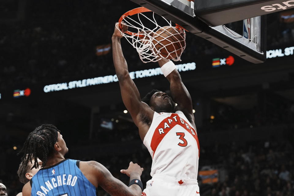 Toronto Raptors' O.G. Anunoby dunks on Orlando Magic's Paolo Banchero during the first half of an NBA basketball game, Saturday, Dec. 3, 2022 in Toronto. (Chris Young/The Canadian Press via AP)