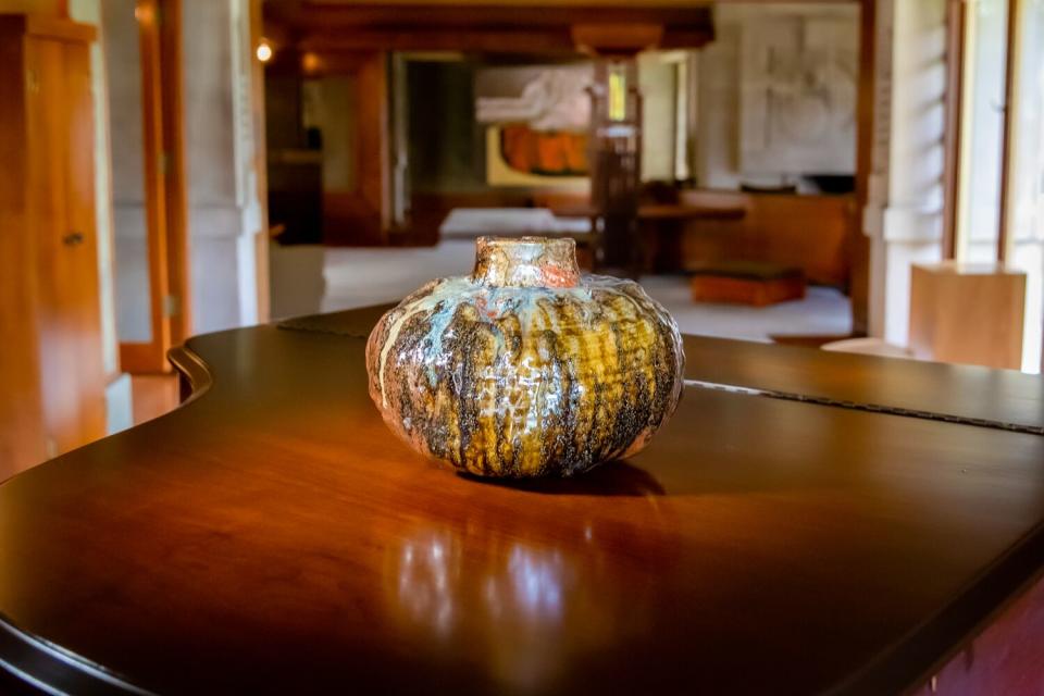 A ceramic piece is photographed inside the Hollyhock House