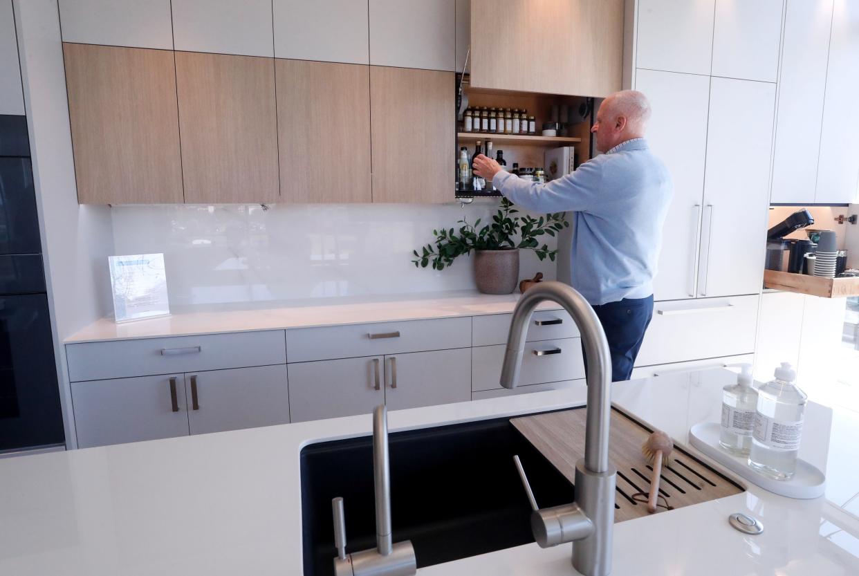 Local developer Scott Graby shows off a replica of what kitchens will look like in the upcoming luxury condominiums to be built in the second phase of the Fountains development.