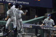 Tampa Bay Rays' Brandon Lowe celebrates a two-run home run with Willy Adames during the fifth inning in Game 2 of the baseball World Series against the Los Angeles Dodgers Wednesday, Oct. 21, 2020, in Arlington, Texas. (AP Photo/Sue Ogrocki)