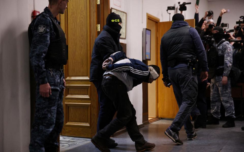 A suspect is escorted into court