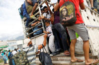 A Honduran migrant, part of a caravan trying to reach the U.S., looks on inside a truck during a new leg of their travel in Chiquimula , Guatemala October 16, 2018. REUTERS/Edgard Garrido