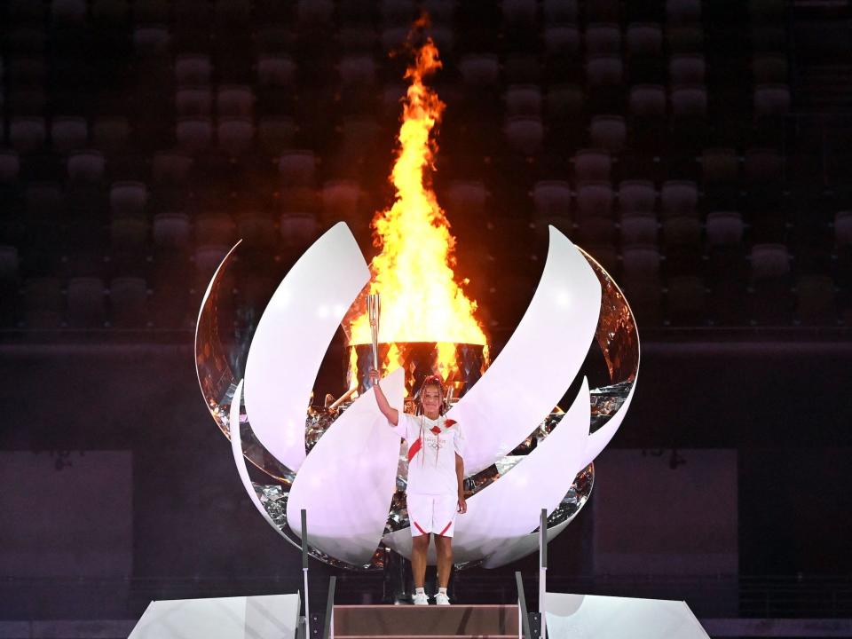 Japanese tennis player Naomi Osaka poses after lighting the Olympic Cauldron