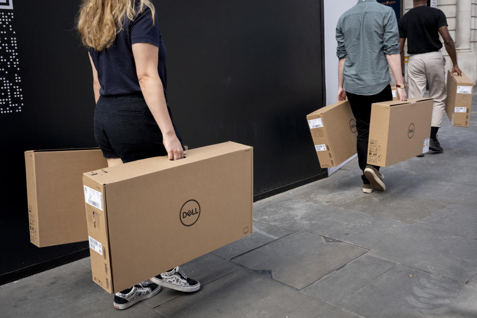 Company employees struggle to carry heavy boxes that contain Dell computing items through West End Streets, on 23rd August 2022, in London, England. (Photo by Richard Baker / In Pictures via Getty Images)