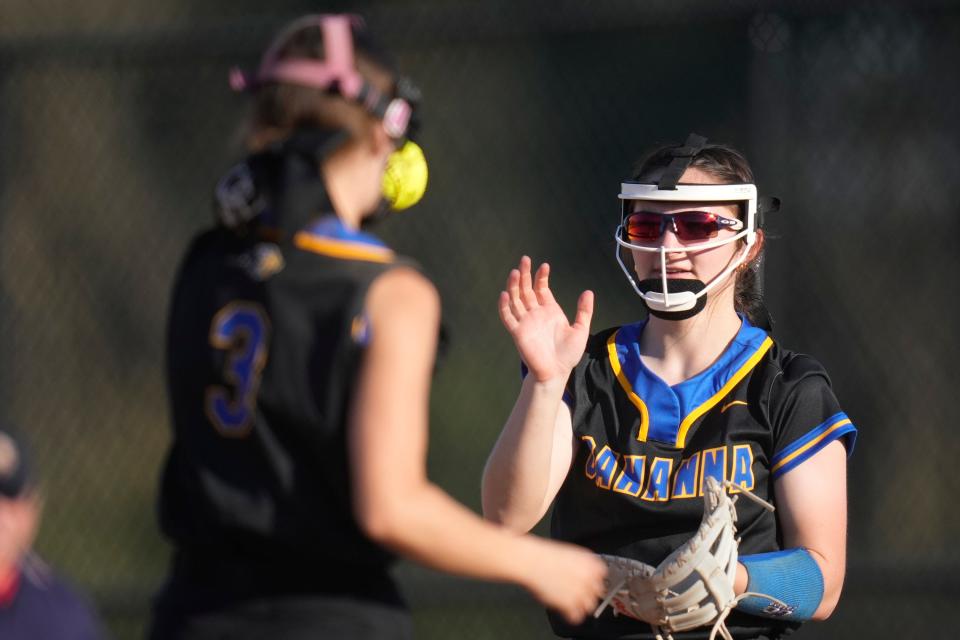 Apr 13, 2023; Gahanna, Ohio, United States;  Gahanna Lincoln's Grace Miller (11) catches a pass in between innings from Mattie Bailey (3) during the softball game between Gahanna Lincoln and New Albany hosted by Gahanna Lincoln on Thursday evening. Mandatory Credit: Joseph Scheller-The Columbus Dispatch