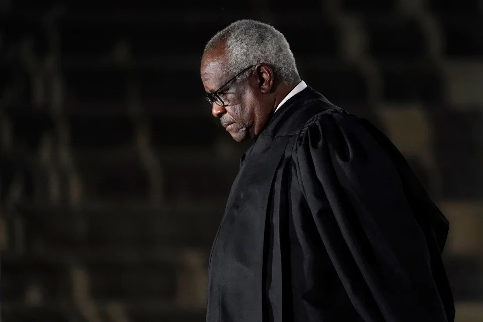 Supreme Court Justice Clarence Thomas listens as President Donald Trump speaks before administering the Constitutional Oath to Amy Coney Barrett on the South Lawn of the White House in Washington, Monday, Oct. 26, 2020, after she was confirmed by the Senate earlier in the evening. (AP Photo/Patrick Semansky)