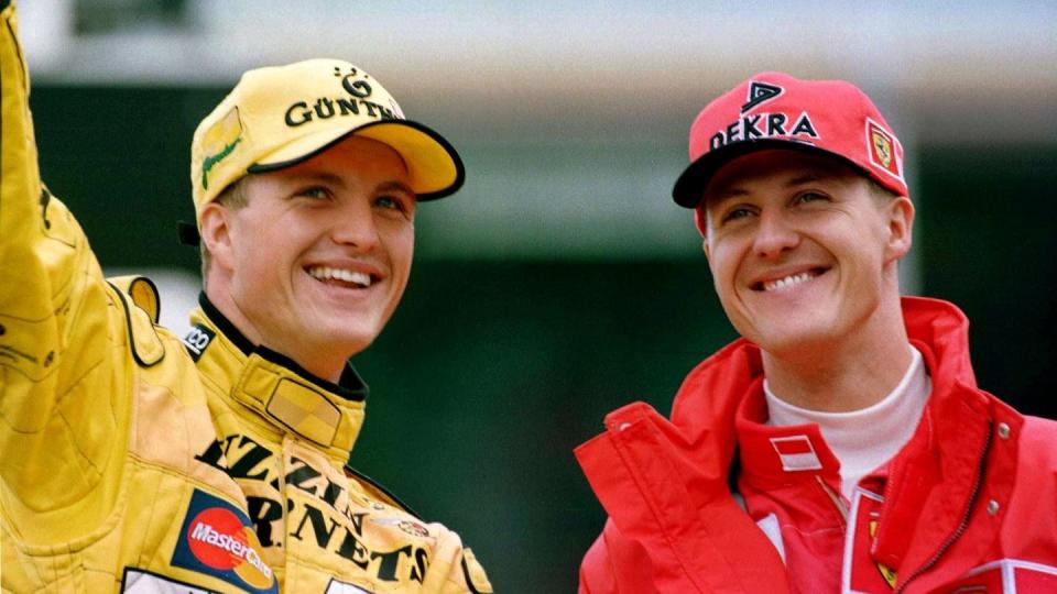 Die Brüder Michael Schumacher (r, Ferrari) und Ralf Schumacher (Jordan) winken nach dem Großen Preis von Deutschland auf dem Hockenheimring den Zuschauern zu.