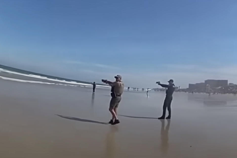 Sheriff's deputies point their guns at a 16-year-old who ran into the water after pulling a gun on a crowded beach in Volusia County, Florida. (Volusia Sheriff's Office)