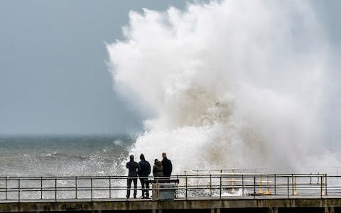 Strong gale force winds, gusting to over 40mph, and the high tide combine to whip huge waves crashing into the sea defences on the promenade in Aberystwyth - Credit: Keith Morris/LNP 