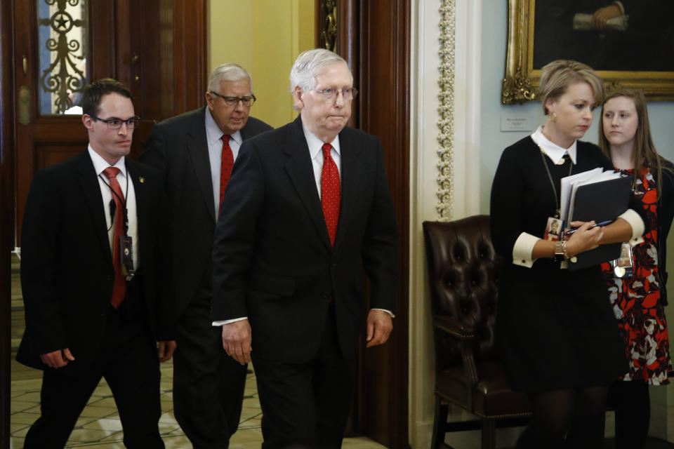 Senate Majority Leader Mitch McConnell, R-Ky., center, walks out of the Senate chamber at the Capitol Tuesday, Jan. 21, 2020, in Washington. President Donald Trump’s impeachment trial quickly burst into a partisan fight Tuesday as proceedings began unfolding at the Capitol. (AP Photo/Steve Helber)