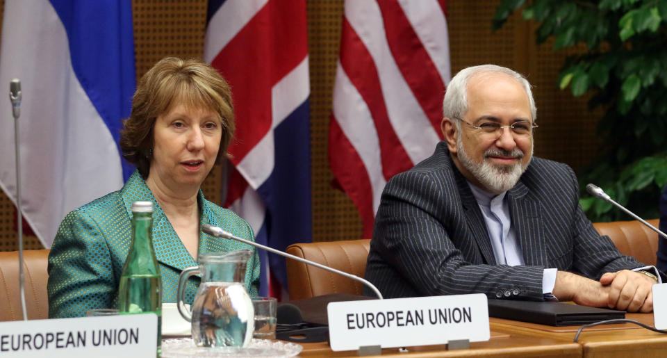 European Union foreign policy chief Catherine Ashton, left, and Iranian Foreign Minister Mohamad Javad Zarif, right, wait for the start of closed-door nuclear talks in Vienna, Austria, Tuesday, March 18, 2014. Ashton and Zarif have launched a new round of nuclear talks between Tehran and six world powers, putting a reported tiff behind them. The two sides hope to reach an agreement by July that trims Iran's nuclear activities in exchange for an end to sanctions choking Tehran's economy. (AP Photo/Ronald Zak)