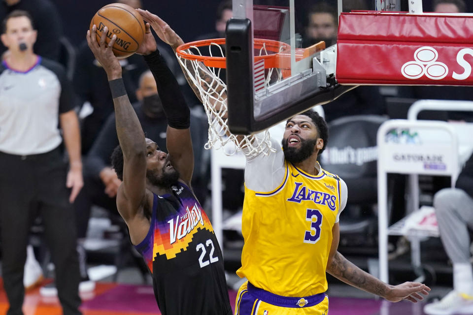 Phoenix Suns center Deandre Ayton (22) dunks against Los Angeles Lakers forward Anthony Davis (3) during the second half of Game 2 of an NBA basketball first-round playoff series Tuesday, May 25, 2021, in Phoenix. The Lakers won 109-102. (AP Photo/Ross D. Franklin)