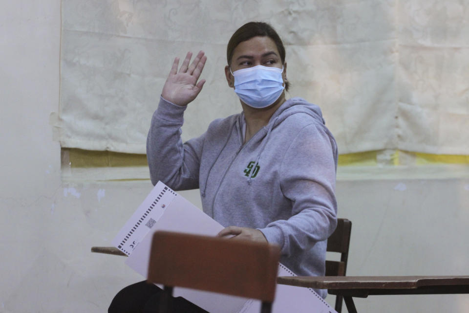 Vice presidential candidate, Davao City Mayor Sara Duterte, running mate of Ferdinand Marcos Jr. waves as she votes at a polling center in Davao City, southern Philippines on Monday, May 9, 2022. Filipinos were voting for a new president Monday, with the son of an ousted dictator and a champion of reforms and human rights as top contenders in a tenuous moment in a deeply divided Asian democracy. (AP Photo/Manman Dejeto)