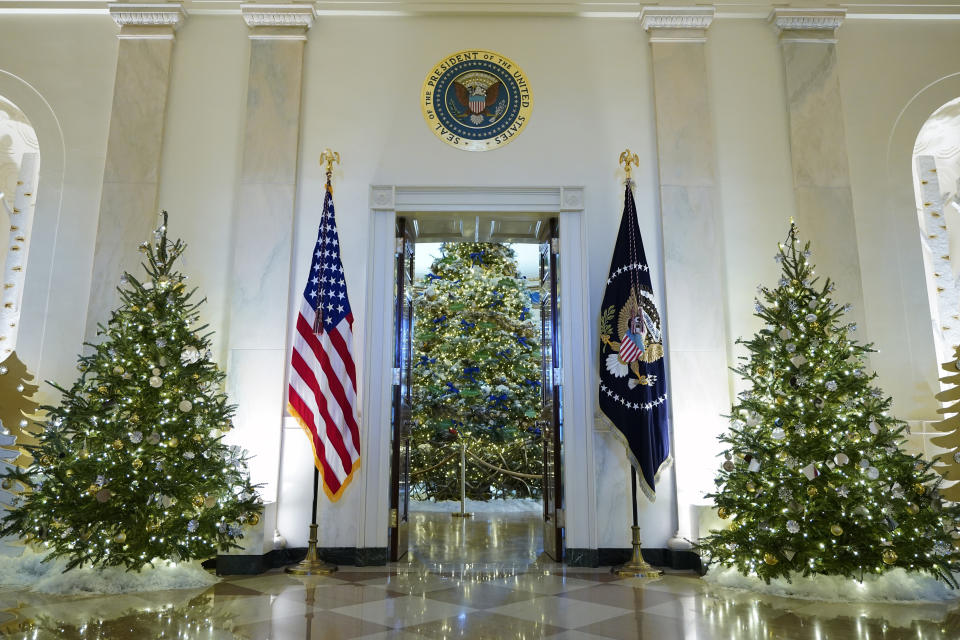FILE - Cross Hall and the Blue Room of the White House are decorated for the holiday season during a press preview of holiday decorations at the White House, Nov. 28, 2022, in Washington. President Joe Biden celebrated a quiet Christmas with his family at the White House over a record-setting cold and windy weekend in the nation’s capitol. (AP Photo/Patrick Semansky, File)