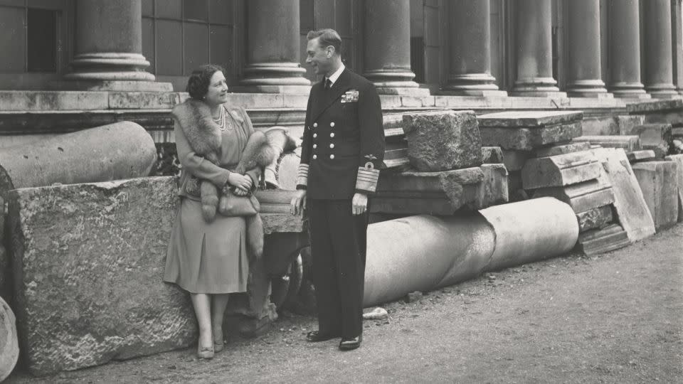 King George VI and Queen Elizabeth look comfortingly at each other a they survey the debris after bombing damaged Buckingham Palace in 1940. - Cecil Beaton/Royal Collection Trust